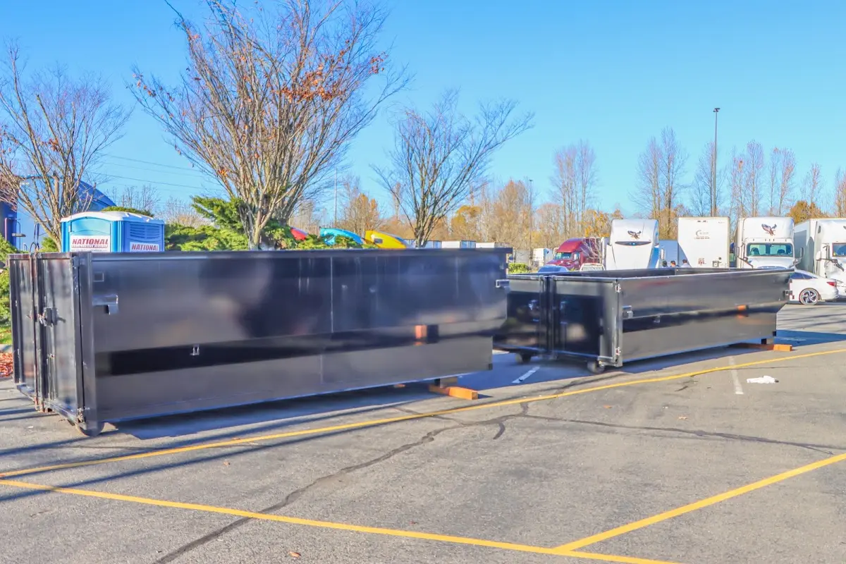 Professional dumpster rental service with roll-off container on residential driveway in Wonder Lake